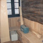 OLD BREWERY BARRELS HAVE BEEN CUT DOWN TO COVER PART OF ONE WALL